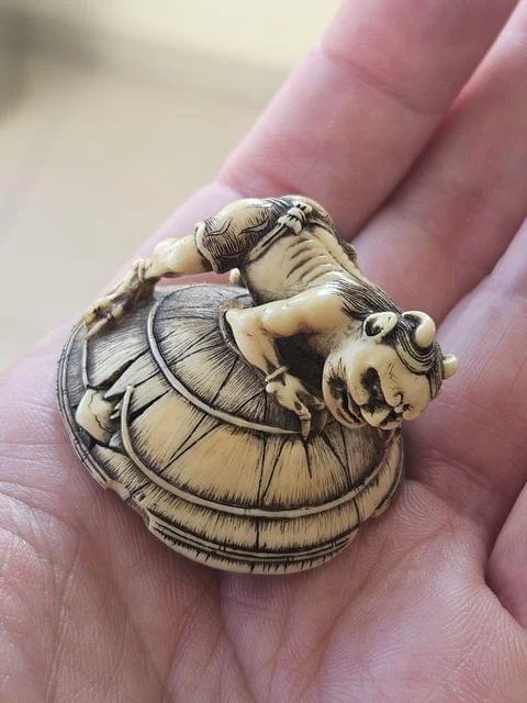 Netsuke of Oni on Barrel with Sword and Scabbard – Edo Period